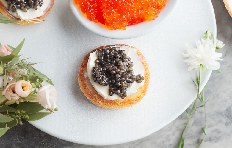 Black caviar served  with potato and cream, photo by Gourmet Food Store