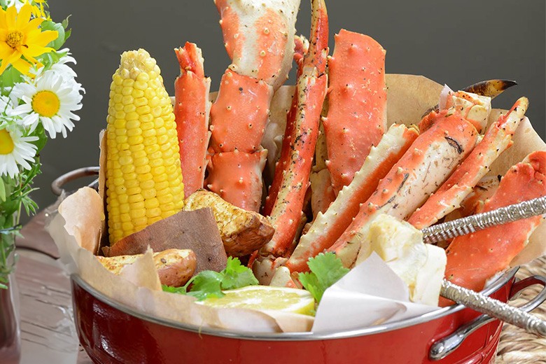 Delicious crab legs served with potatoes and corn, photo by Gourmet Food Store