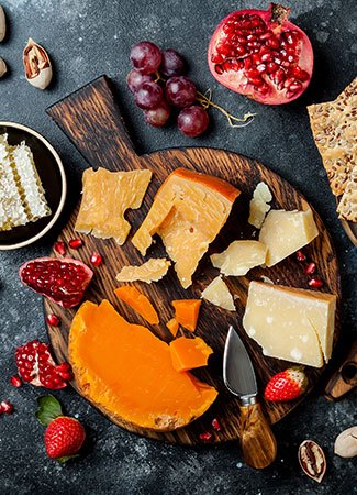  an assortment of fall cheeses on a board, gourmet food store