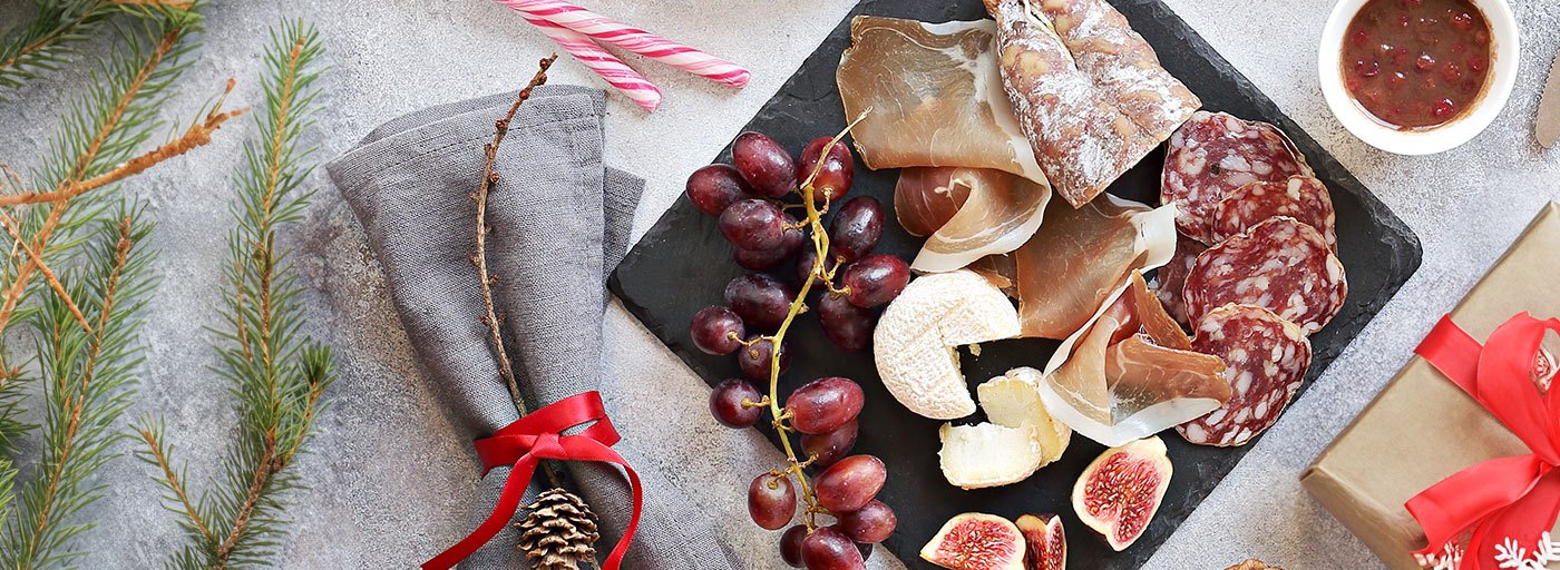 view of delicious cheeses and meats on a board