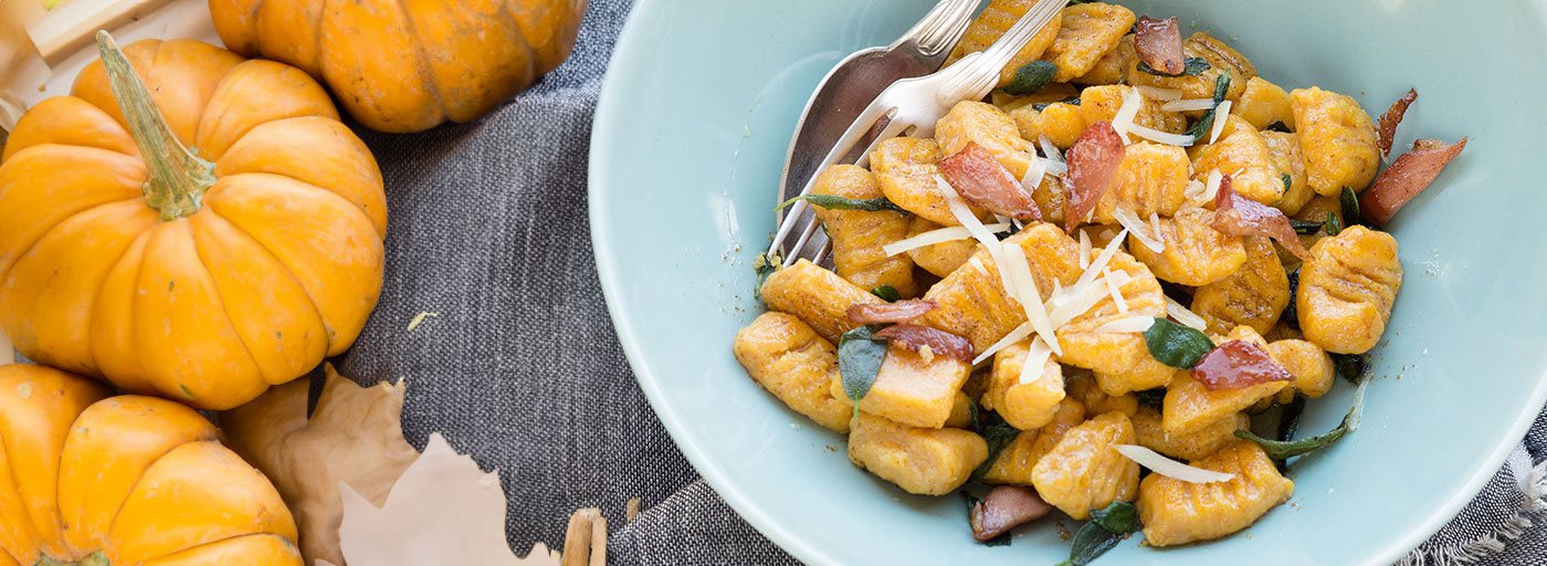 a plate of orange pumpkin gnocchi with bacon, image by Gourmet Food Store