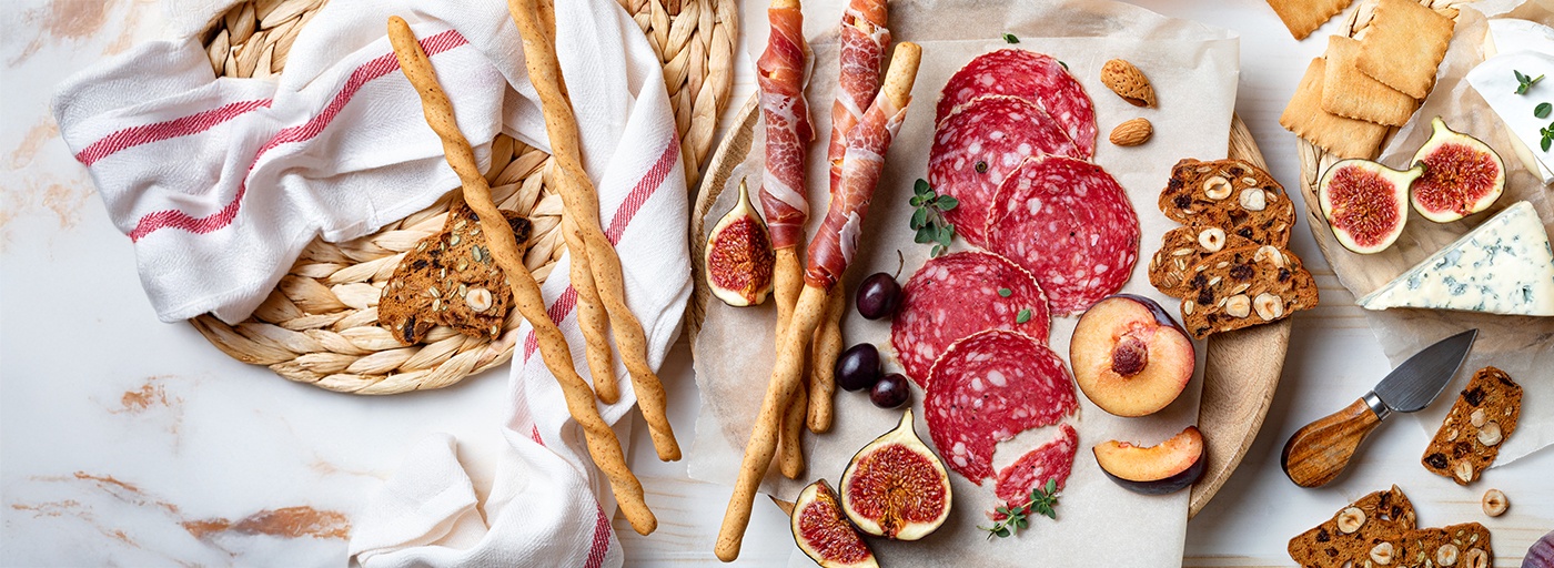 view of delicious cheeses and meats on a board