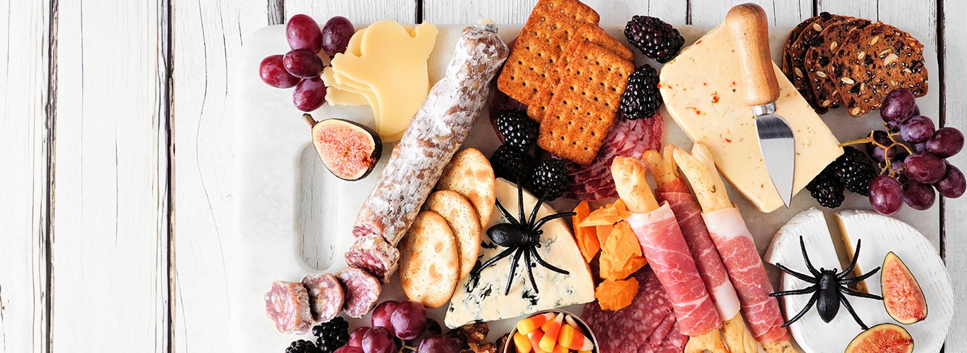 view of delicious and spooky halloween themed board with cheeses and meats